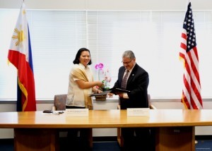 Consul General De La Vega (left) exchanging the Cooperative Agreement with Regional Administrator Rosales.