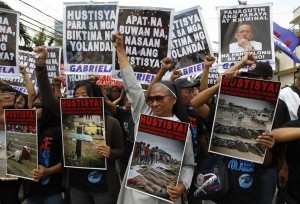 A nun joins the women's advocacy group GABRIELA and victims of Typhoon Haiyan, during a International Women's Day protest rally outside the residence of President Benigno Aquino in Quezon city, metro Manila March 8, 2014. The protesters are denouncing what they say is the government's neglect of disaster victims in central Philippines. On March 8 activists around the globe celebrate International Women's Day, which dates back to the beginning of the 20th Century and has been observed by the United Nations since 1975. The UN writes that it is an occasion to commemorate achievements in women's rights and to call for further change. (MNS photo)