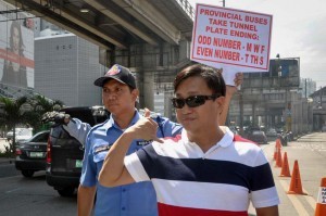 Metropolitan Manila Development Authority (MMDA) Chairman Francis Tolentino (right) personally oversees on Tuesday the implementation of the odd-even scheme for provincial buses plying the stretch of EDSA. The buses will be allowed in tunnels along EDSA until January. (MNS photo)