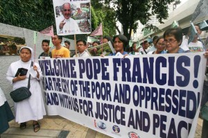 Members of different church organizations troop outside the Apostolic Nunciature along Taft Avenue in Manila on Monday to deliver postcards addressed to Pope Francis. The postcards contain images of problems facing various sectors of Philippine society.(MNS photo)