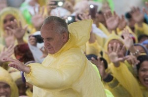 Pope Francis wears a plastic poncho as he waves to well wishers after a mass in Tacloban. (MNS photo)