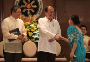 President Benigno S. Aquino III, assisted by Lenovo country general manager Michael Ngan, presents the Lenovo Most Innovative Project award to Order of Asclepius during the Ten Accomplished Youth Organizations Year 12 (TAYO 12) Awarding Ceremonies at the Heroes Hall of the Malacañan Palace on Tuesday (February 24, 2015). Since 2002, TAYO Awards recognizes and supports the outstanding contributions of youth organizations to the country. (MNS photo)