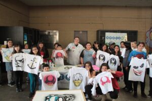 students working with professionals in various types of activities. With Photography, Graffiti Art, Music, History, Fashion and many more, our kids develop numerous skills a that will help them lead into a bright future. (courtesy of Woodraft Rangers Facebook page)