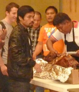 Tempter Manny: Boxing Champion Manny Pacquiao waits to be served during the Temptation Night where contestants who quit the weight loss contest crossed the line to join the table to enjoy their meals. Handsome cash prizes await the winners on April 19 at the final weigh in.