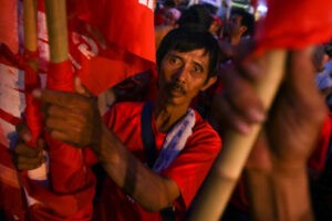 A worker joins call for higher wages as he attends a Labor Day protest in Manila on Friday. Workers' groups say lack of jobs and low wages in the country force many Filipinos to find greener pastures abroad. (MNS photo)
