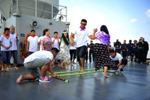 SOUTH CHINA SEA (May 10, 2015) Culinary Specialist 2nd Class Johnmatthew Relova and Culinary Specialist Seaman Agnelia Morena perform the traditional Filipino dance, Tinikling, during an Asian-Pacific Islander Heritage Celebration on the ship's main deck. Blue Ridge is conducting patrols, strengthening and fostering relationships within the Indo-Asia Pacific region. (U.S. Navy photo by Mass Communication Specialist 2nd Class Phillip Pavlovich/Released)