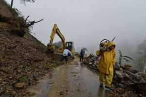 Department of Public Works and Highways personnel rush to clear a portion of Kennon Road that was blocked by a landslide at the height of tropical storm Egay's onslaught Monday in Benguet province. Storm signals were raised in several provinces as Egay barreled accross Luzon. (MNS photo)