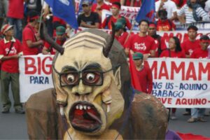 Protesters march with an effigy of President Benigno Aquino towards Batasang Pambansa in Quezon city on Monday, July 27. Aquino will address the joint session of Congress, delivering his last State of the Nation speech this afternoon. (MNS photo)