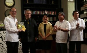 President Benigno S. Aquino III receives a copy of the book entitled “The Aquino Legacy: An Enduring Narrative” from the authors Elfren Cruz and Neni St. Romana Cruz during the book launching at the Writers' Bar of the Raffles Hotel in One Raffles Drive, Makati Avenue, Makati City on Thursday (November 26). Also in photo are Education Secretary Armin Luistro and Communications Secretary Herminio Coloma. (MNS photo)